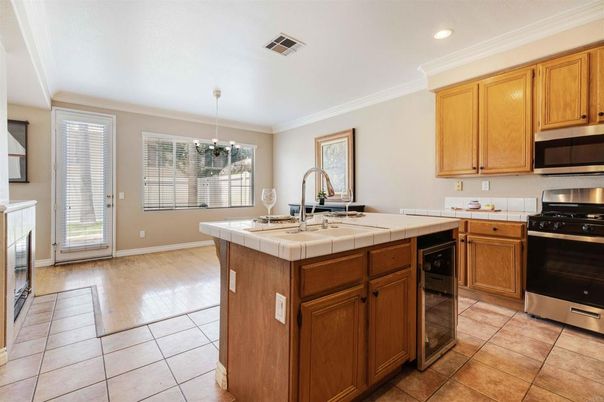Fireplace, Interior, Kitchen, Pendant Lights, Recessed Lighting, Stainless Steel Appliances, Tile Countertops, Wood Texture Flooring