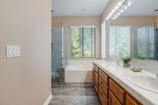 Bathroom, Dual Sink Vanities, Glass Shower, Interior, Recessed Lighting, Tile Countertops, Wood Texture Flooring