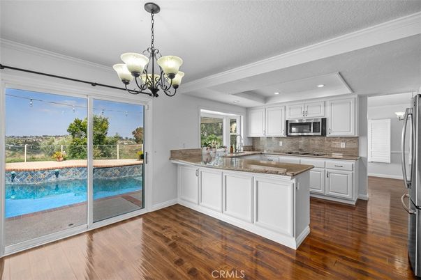 Chandelier, Interior, Kitchen, Pendant Lights, Recessed Lighting, Stainless Steel Appliances, Wood Texture Flooring