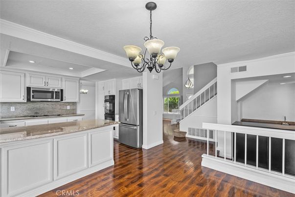 Chandelier, Interior, Kitchen, Pendant Lights, Recessed Lighting, Stainless Steel Appliances, Wood Texture Flooring