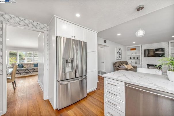 Fireplace, Interior, Kitchen, Living room, Pendant Lights, Recessed Lighting, Stainless Steel Appliances, Stone Walls, Wood Texture Flooring