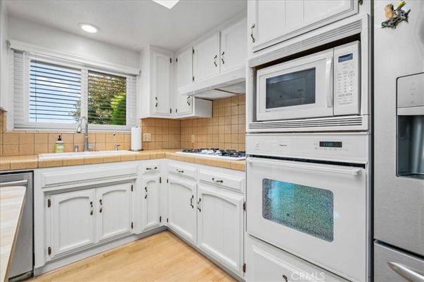Interior, Kitchen, Recessed Lighting, Tile Countertops, Wood Texture Flooring