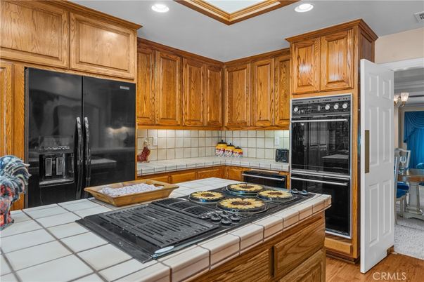 Interior, Kitchen, Recessed Lighting, Tile Countertops, Wood Texture Flooring