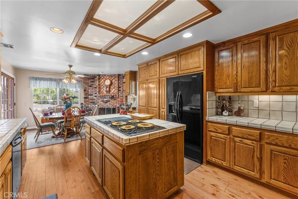 Dining room, Fireplace, Interior, Kitchen, Recessed Lighting, Stone Walls, Tile Countertops, Wood Texture Flooring
