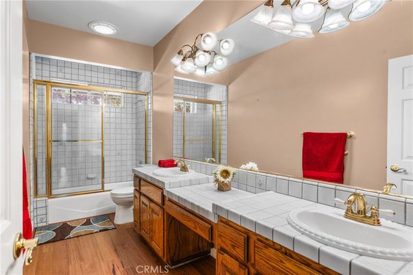 Bathroom, Dual Sink Vanities, Glass Shower, Interior, Recessed Lighting, Tile Countertops, Wood Texture Flooring
