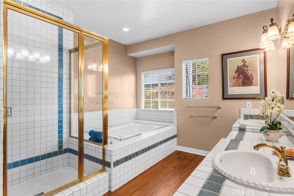Bathroom, Dual Sink Vanities, Glass Shower, Interior, Recessed Lighting, Tile Countertops, Wood Texture Flooring