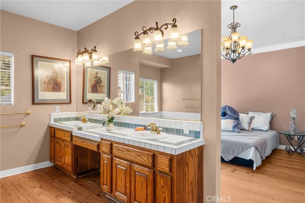 Bathroom, Chandelier, Dual Sink Vanities, Interior, Tile Countertops, Wood Texture Flooring