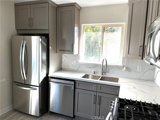 Interior, Kitchen, Marble Walls, Stainless Steel Appliances, Wood Texture Flooring