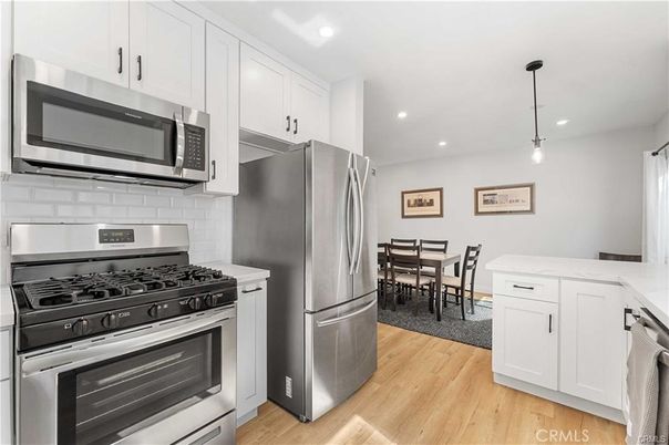Dining room, Interior, Kitchen, Pendant Lights, Recessed Lighting, Stainless Steel Appliances, Wood Texture Flooring
