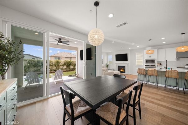 Chandelier, Dining room, Fireplace, Interior, Kitchen, Living room, Pendant Lights, Recessed Lighting, Stainless Steel Appliances, Wood Texture Flooring