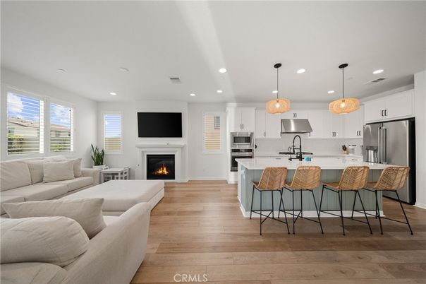 Fireplace, Interior, Kitchen, Living room, Pendant Lights, Recessed Lighting, Stainless Steel Appliances, Wood Texture Flooring