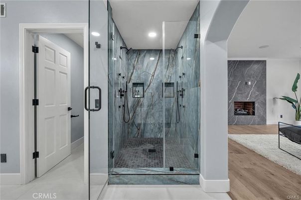 Bathroom, Fireplace, Glass Shower, Interior, Marble Walls, Recessed Lighting, Wood Texture Flooring