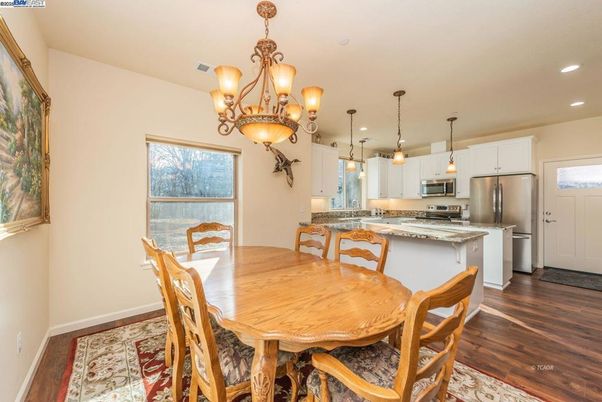 Chandelier, Dining room, Interior, Kitchen, Pendant Lights, Recessed Lighting, Stainless Steel Appliances, Wood Texture Flooring