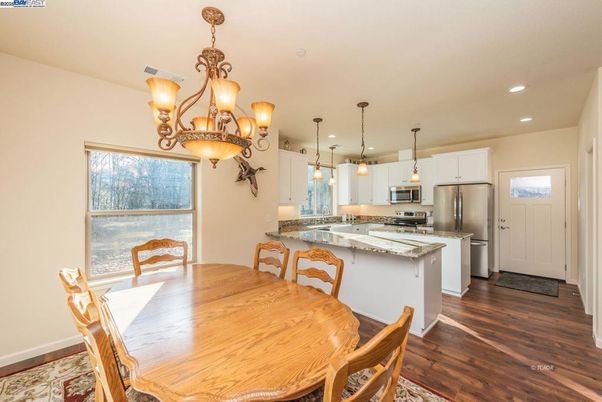 Chandelier, Dining room, Interior, Kitchen, Pendant Lights, Recessed Lighting, Stainless Steel Appliances, Wood Texture Flooring