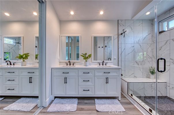 Bathroom, Dual Sink Vanities, Glass Shower, Interior, Marble Walls, Recessed Lighting, Wood Texture Flooring