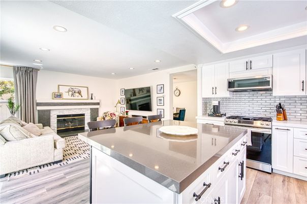 Fireplace, Interior, Kitchen, Living room, Recessed Lighting, Stainless Steel Appliances, Wood Texture Flooring