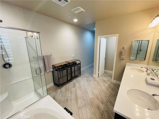 Bathroom, Dual Sink Vanities, Glass Shower, Interior, Recessed Lighting, Wood Texture Flooring