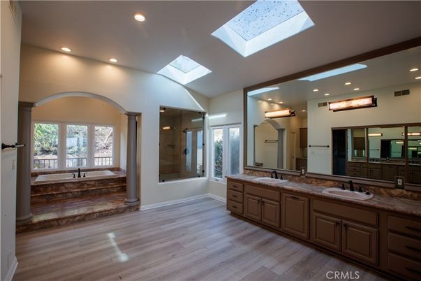 Bathroom, Dual Sink Vanities, Glass Shower, Interior, Recessed Lighting, Wood Texture Flooring