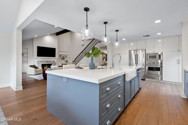 Fireplace, Interior, Kitchen, Living room, Pendant Lights, Recessed Lighting, Stainless Steel Appliances, Wood Texture Flooring