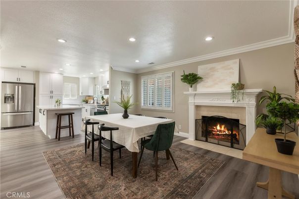 Dining room, Fireplace, Interior, Kitchen, Recessed Lighting, Stainless Steel Appliances, Wood Texture Flooring