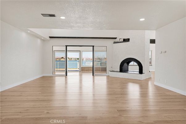 Empty room, Fireplace, Interior, Recessed Lighting, Water, Wood Texture Flooring