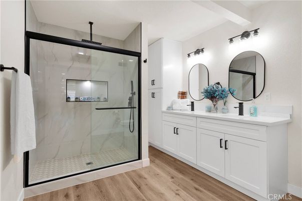 Bathroom, Dual Sink Vanities, Glass Shower, Interior, Marble Walls, Wood Texture Flooring