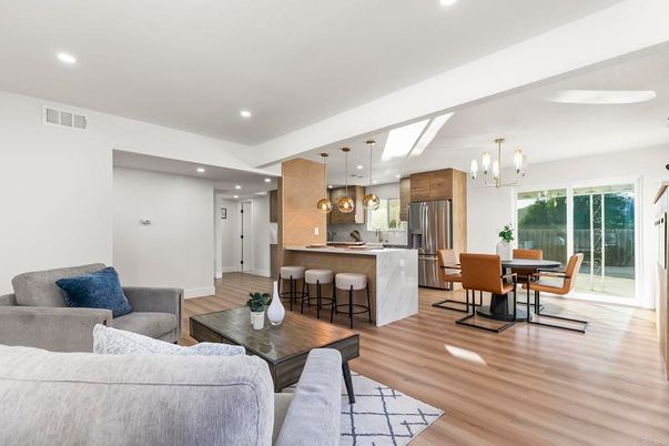 Chandelier, Dining room, Interior, Kitchen, Living room, Pendant Lights, Recessed Lighting, Stainless Steel Appliances, Wood Texture Flooring