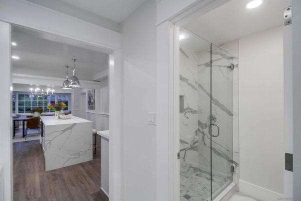 Bathroom, Glass Shower, Interior, Marble Walls, Pendant Lights, Recessed Lighting, Wood Texture Flooring