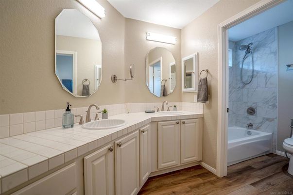 Bathroom, Dual Sink Vanities, Interior, Marble Walls, Tile Countertops, Wood Texture Flooring