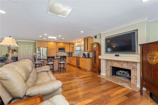 Fireplace, Interior, Kitchen, Living room, Recessed Lighting, Stainless Steel Appliances, Wood Texture Flooring