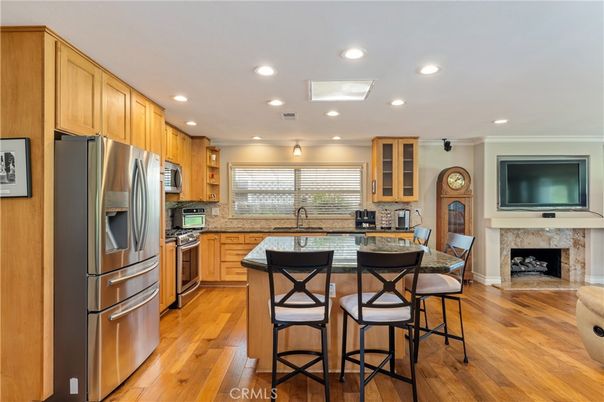 Fireplace, Interior, Kitchen, Recessed Lighting, Stainless Steel Appliances, Wood Texture Flooring
