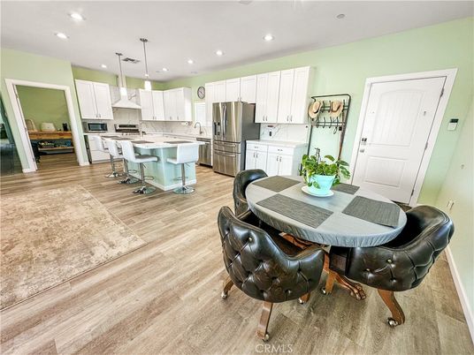 Dining room, Interior, Kitchen, Pendant Lights, Recessed Lighting, Stainless Steel Appliances, Wood Texture Flooring