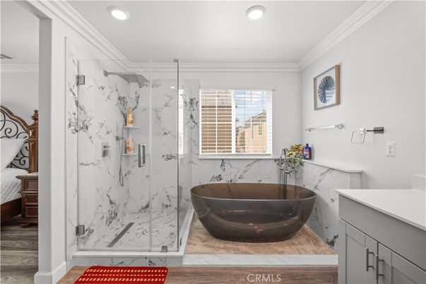 Bathroom, Free Standing Baths, Glass Shower, Interior, Marble Walls, Recessed Lighting, Wood Texture Flooring