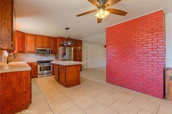 Interior, Kitchen, Pendant Lights, Stainless Steel Appliances, Stone Walls, Tile Countertops