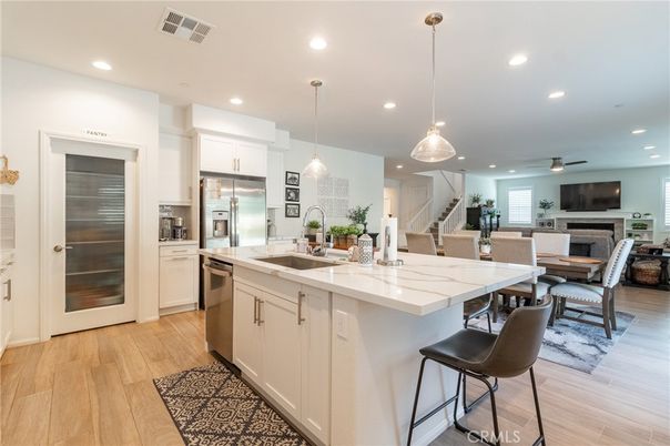 Dining room, Fireplace, Interior, Kitchen, Pendant Lights, Recessed Lighting, Stainless Steel Appliances, Wood Texture Flooring
