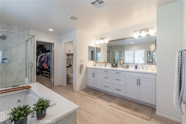 Bathroom, Dual Sink Vanities, Glass Shower, Interior, Marble Walls, Recessed Lighting, Walk-in Closets, Wood Texture Flooring