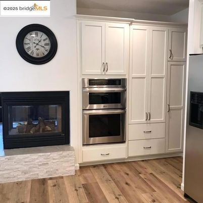 Fireplace, Interior, Kitchen, Stainless Steel Appliances, Wood Texture Flooring