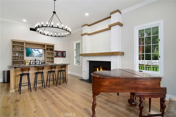 Chandelier, Fireplace, Interior, Pendant Lights, Piano, Recessed Lighting, Wood Texture Flooring