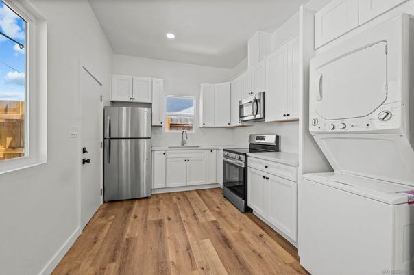 Interior, Kitchen, Recessed Lighting, Washer, Wood Texture Flooring
