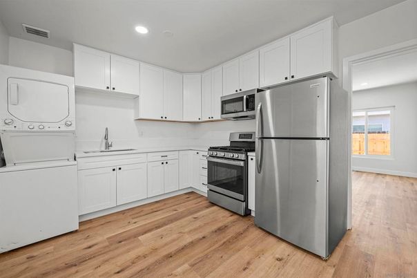 Interior, Kitchen, Recessed Lighting, Stainless Steel Appliances, Washer, Wood Texture Flooring