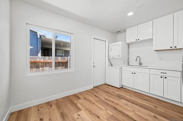 Interior, Kitchen, Recessed Lighting, Washer, Wood Texture Flooring
