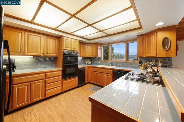 Interior, Kitchen, Recessed Lighting, Tile Countertops, Wood Texture Flooring