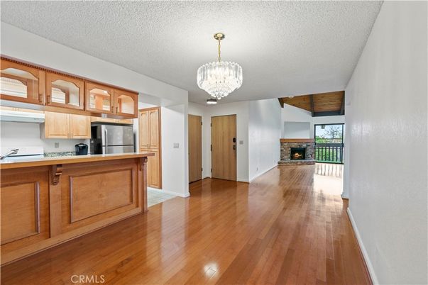 Chandelier, Fireplace, Interior, Kitchen, Stainless Steel Appliances, Wood Texture Flooring
