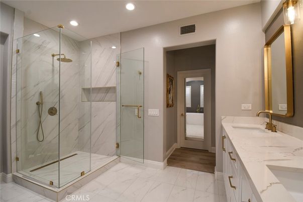 Bathroom, Dual Sink Vanities, Glass Shower, Interior, Marble, Marble Walls, Recessed Lighting, Wood Texture Flooring