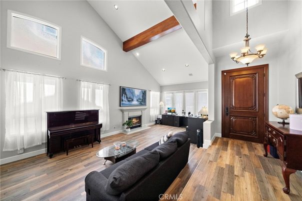 Chandelier, Fireplace, Interior, Living room, Piano, Recessed Lighting, Wooden Beams, Wood Texture Flooring