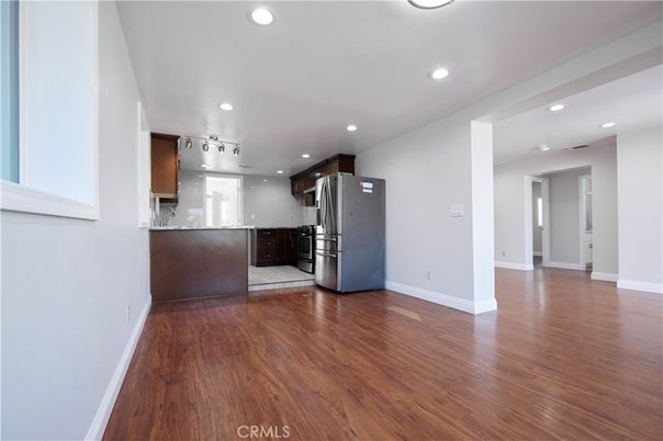 Empty room, Interior, Kitchen, Recessed Lighting, Stainless Steel Appliances, Wood Texture Flooring