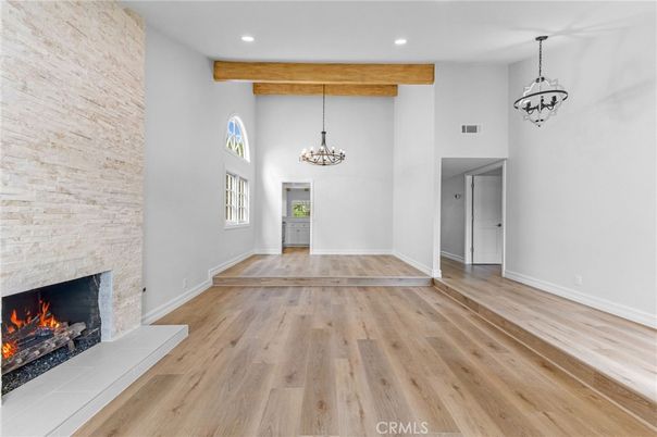 Chandelier, Empty room, Fireplace, Interior, Pendant Lights, Recessed Lighting, Stone Walls, Wooden Beams, Wood Texture Flooring