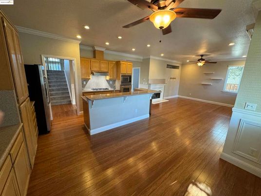 Empty room, Interior, Kitchen, Recessed Lighting, Stainless Steel Appliances, Wood Texture Flooring
