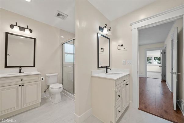 Bathroom, Dual Sink Vanities, Glass Shower, Interior, Recessed Lighting, Wood Texture Flooring