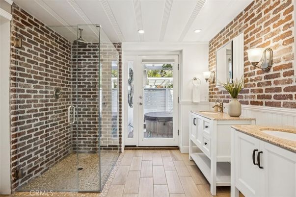Bathroom, Dual Sink Vanities, Glass Shower, Interior, Recessed Lighting, Stone Walls, Wood Texture Flooring
